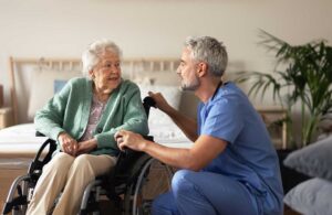 Care staff assisting seniors with daily activities in a cozy common area.