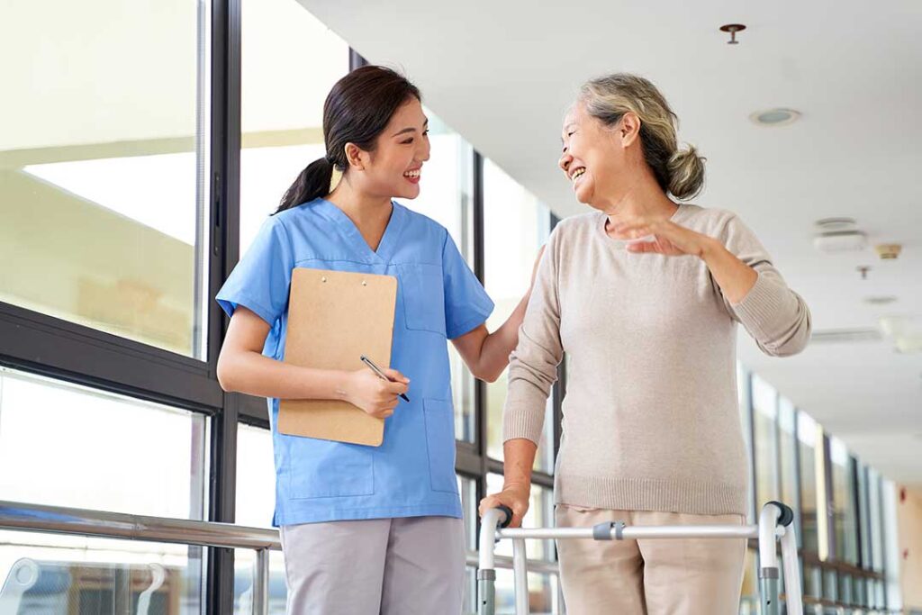 Resident and caregiver review a care plan beside religious items and culturally familiar foods.