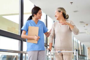 Resident and caregiver review a care plan beside religious items and culturally familiar foods.